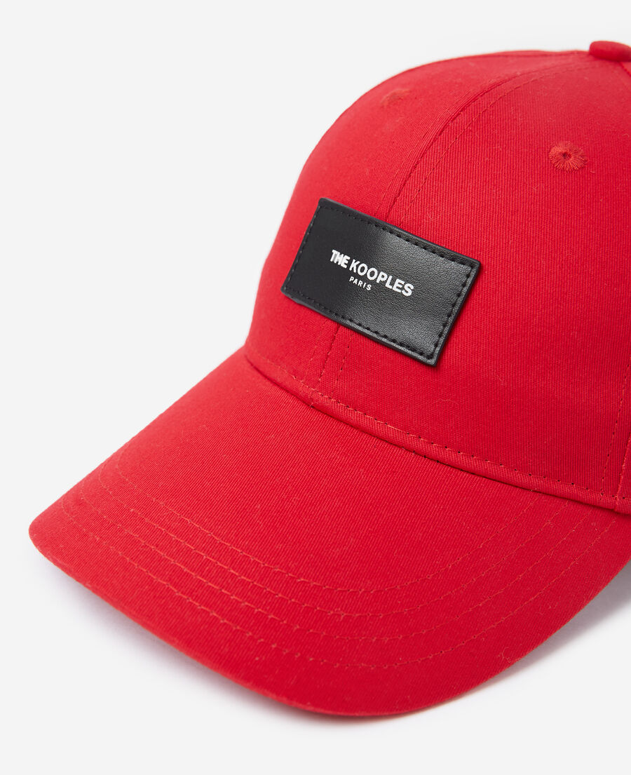 red cap with patch and logo