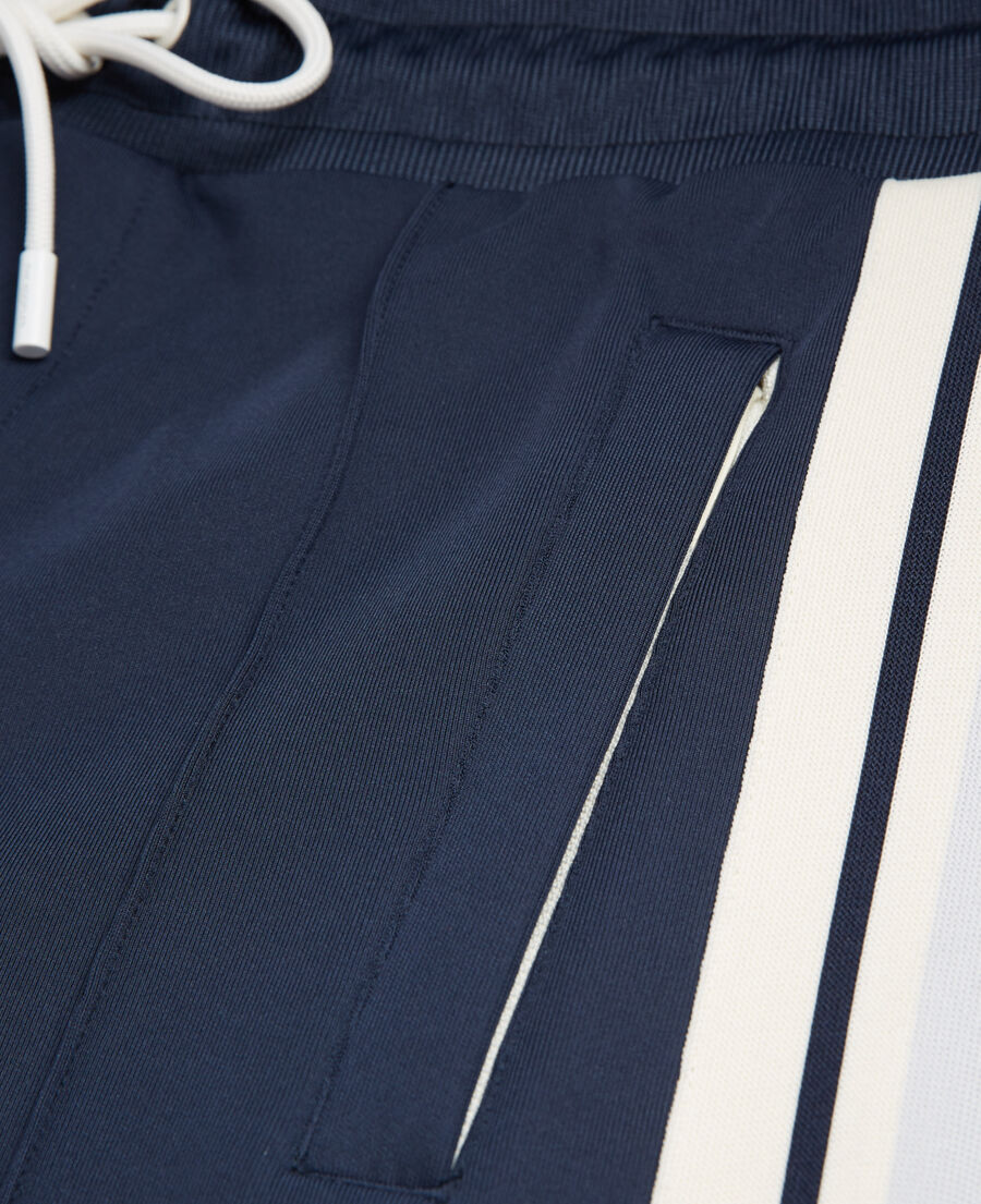 navy blue loose-fit joggers with ecru bands