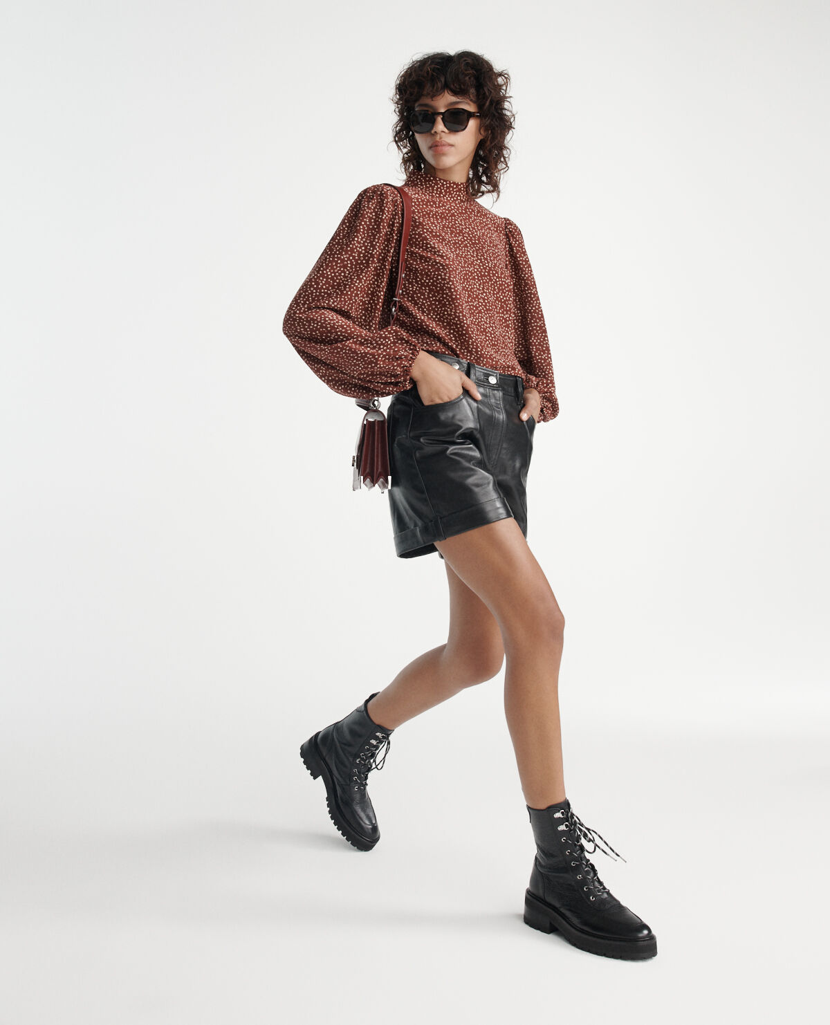 Black leather shorts with cuffs and belt