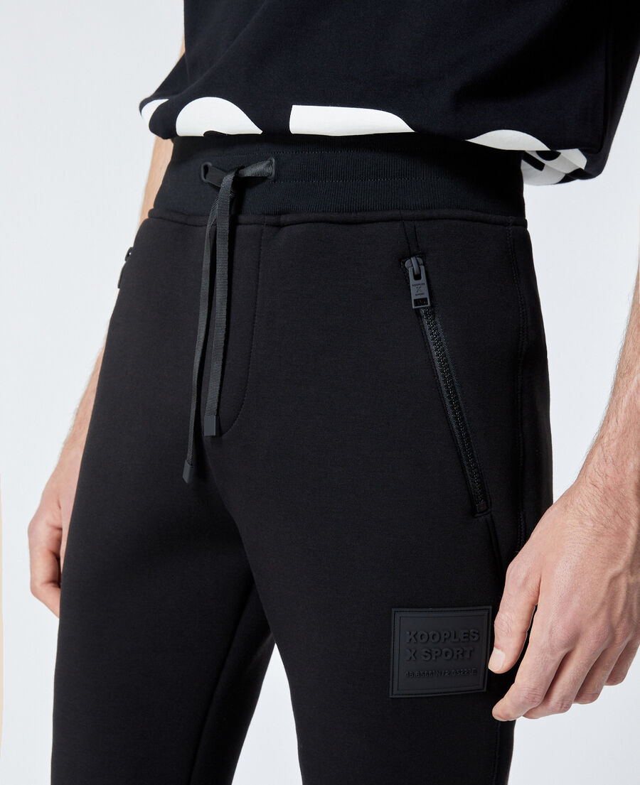 zipped skinny black joggers with logo patch