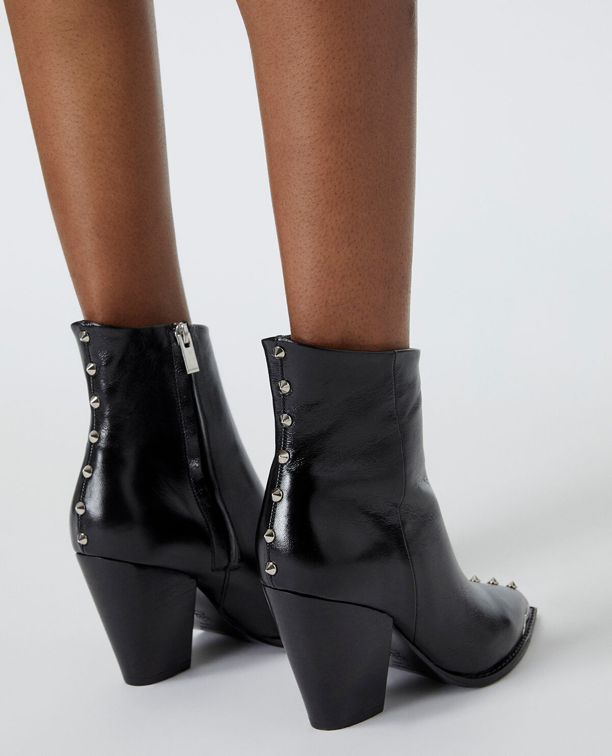 Black leather ankle boots with studs