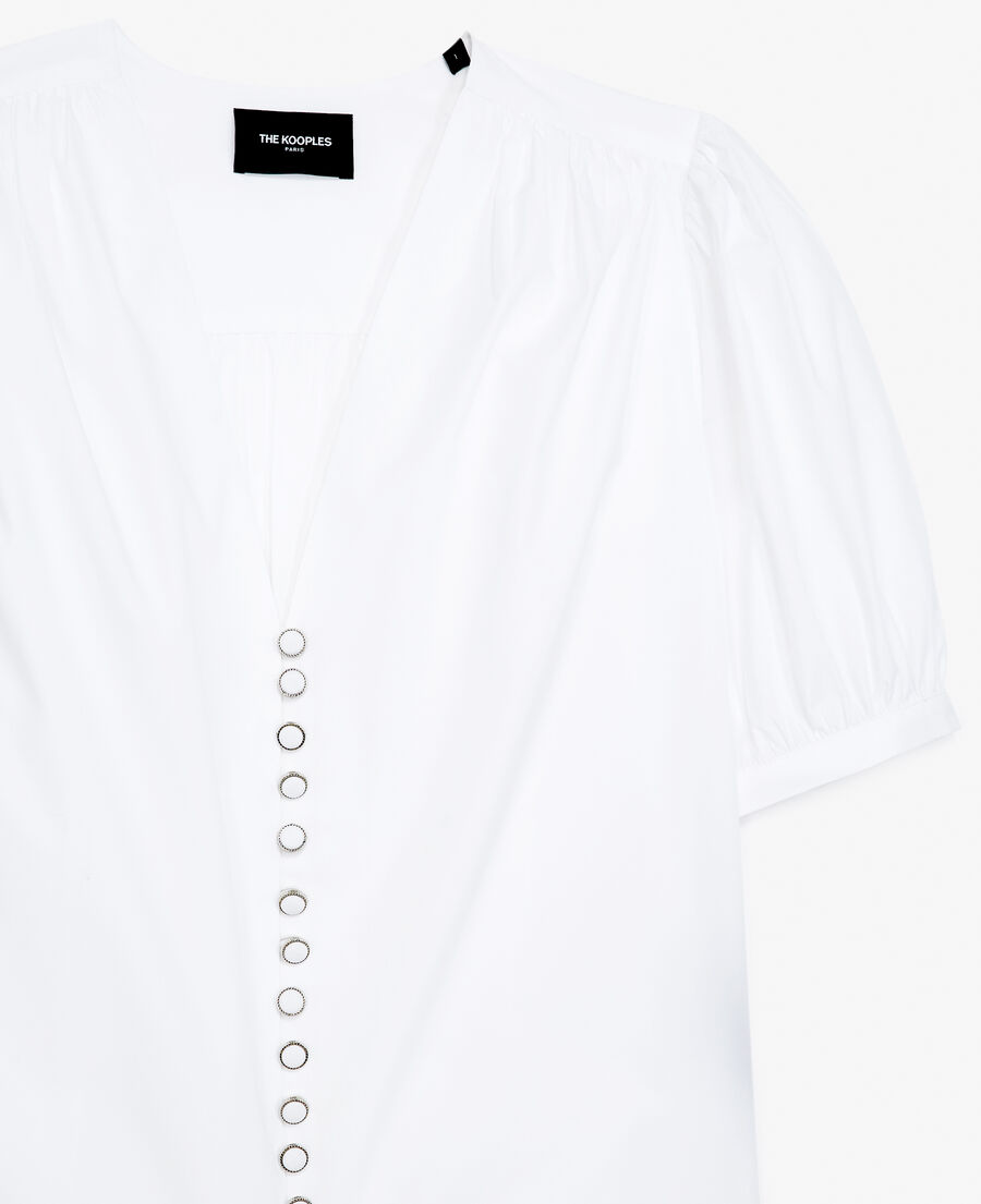 white shirt with v-neck and puffed sleeves