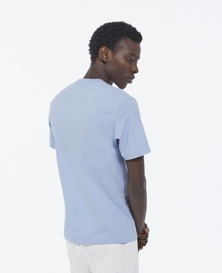 sky blue t-shirt with faded logo on the chest