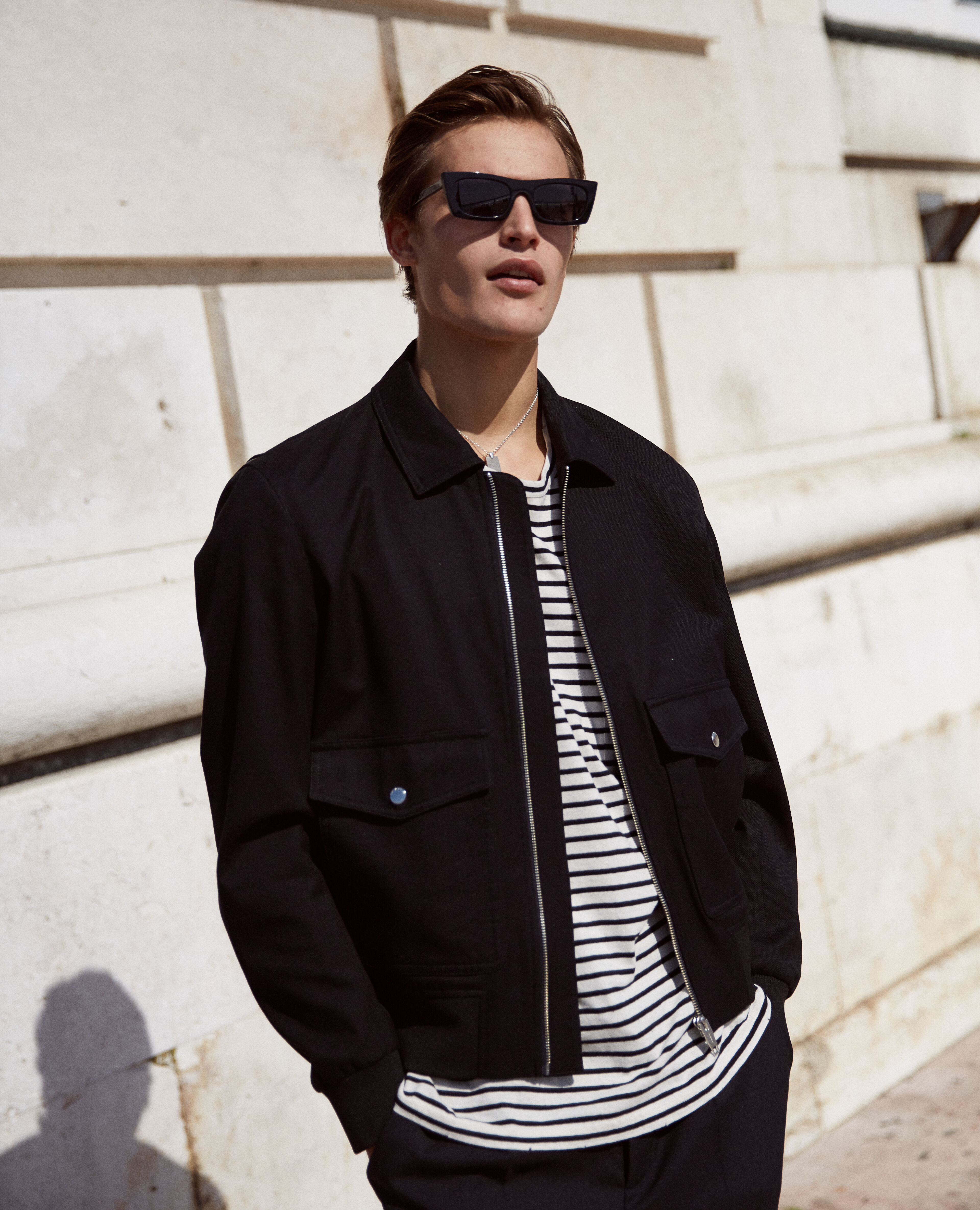 Black gusseted zip-up jacket with leather detail