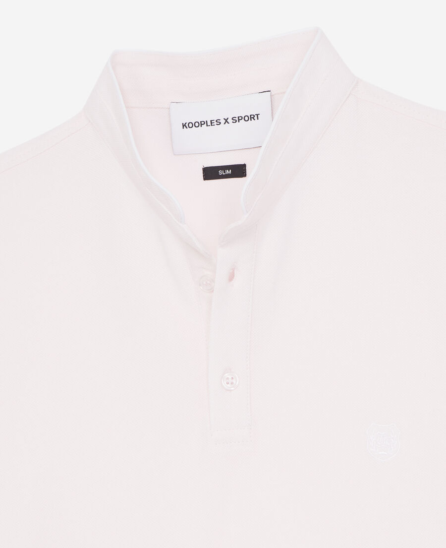 light pink polo shirt with white badge