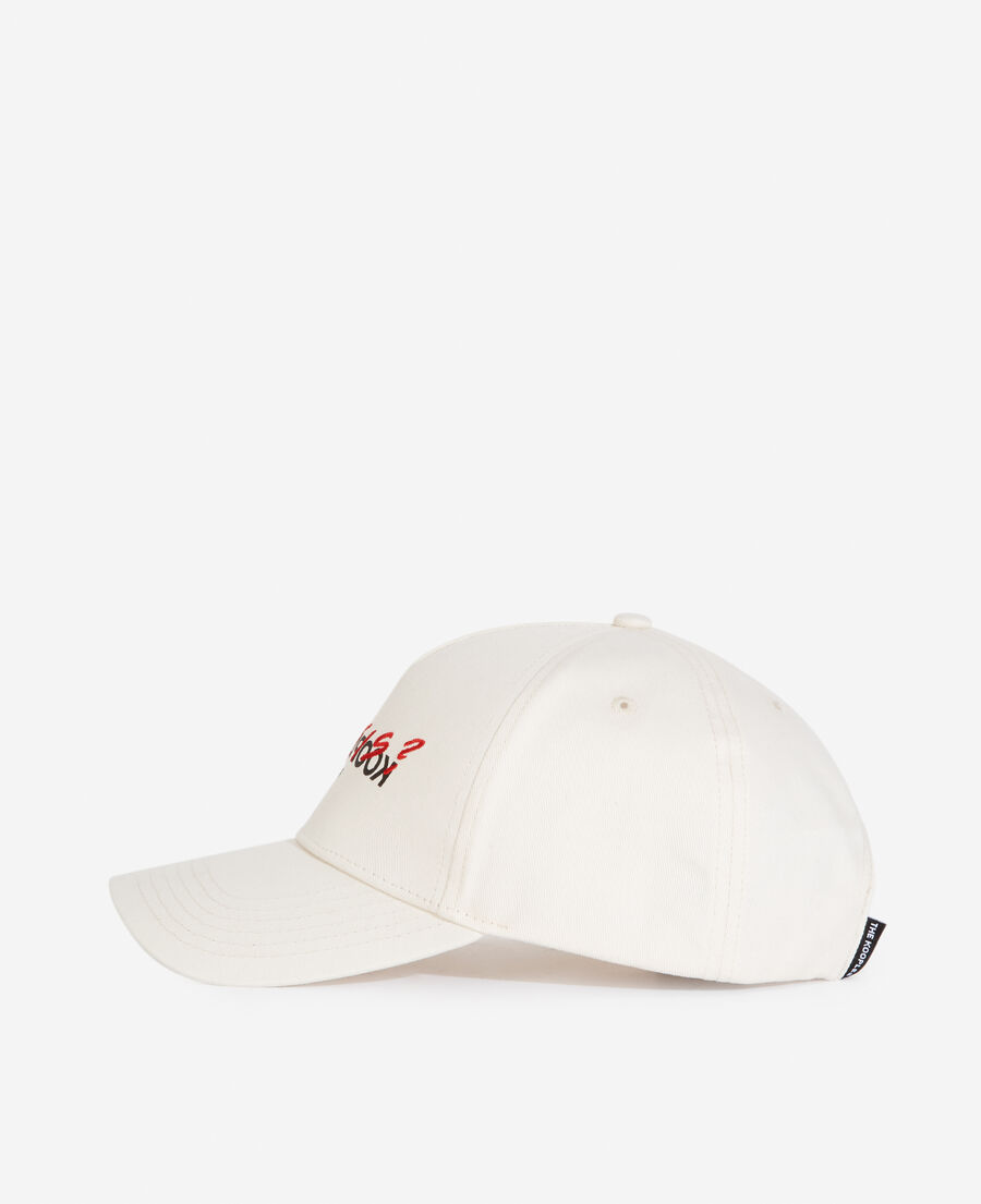 white cotton cap with embroidered “what is”