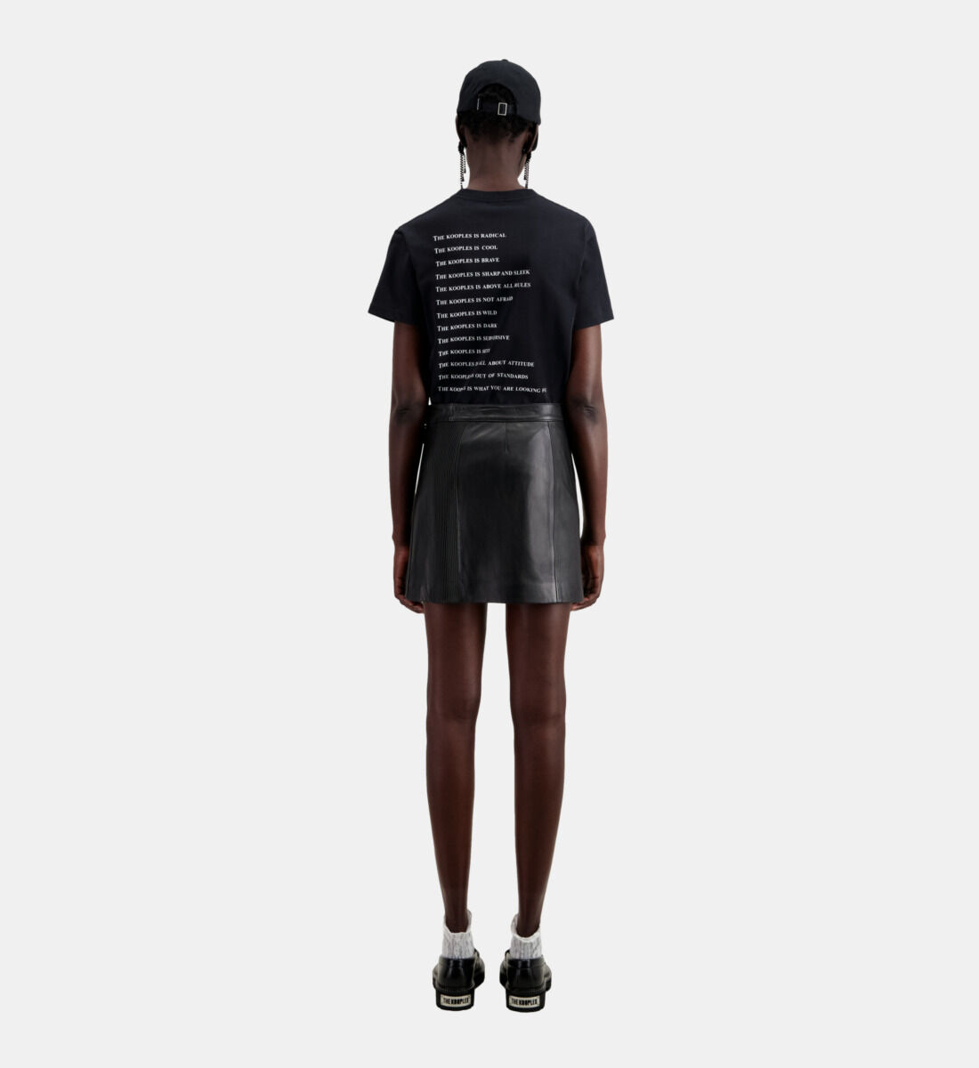 Short black leather skirt with zip and pintuck details The Kooples