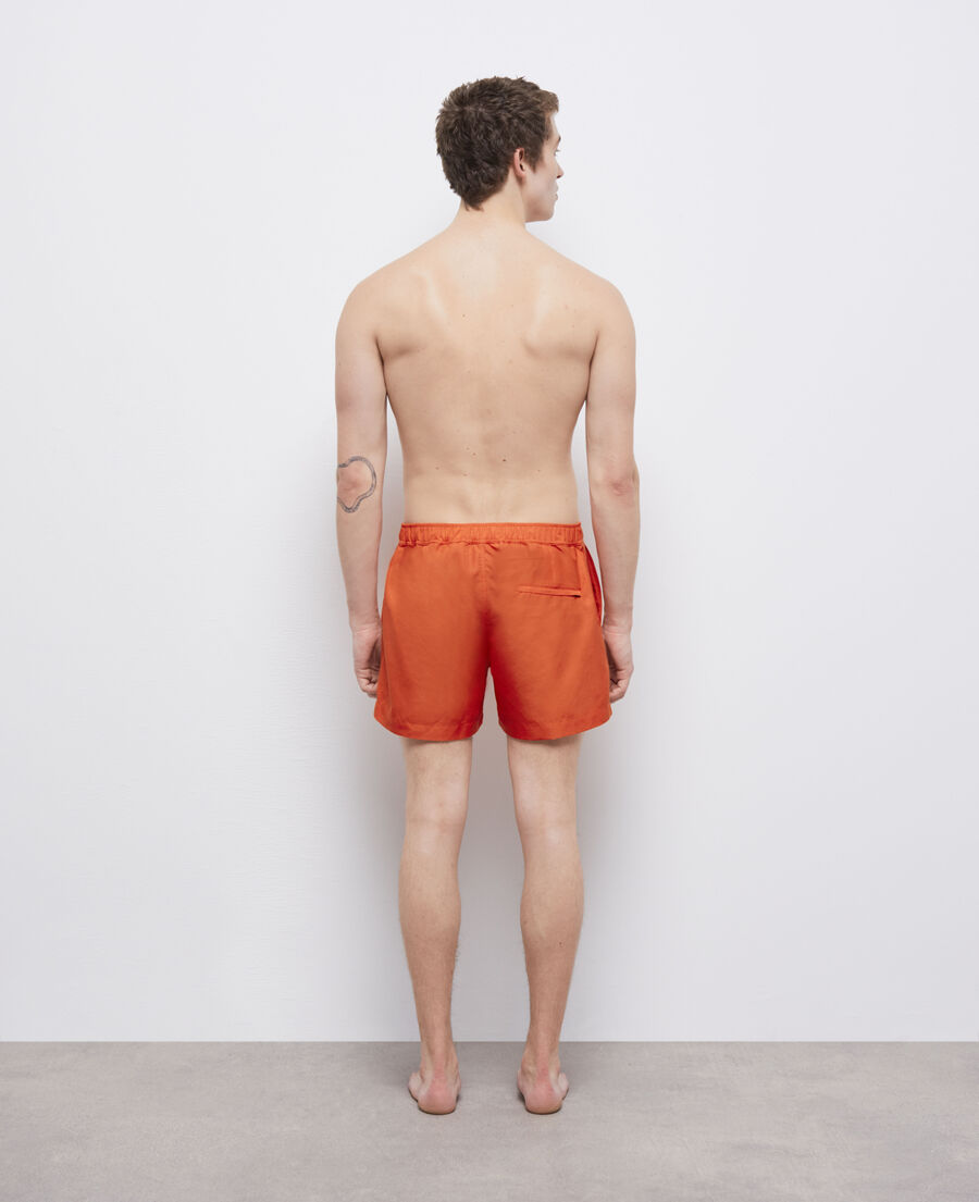 orange swim shorts with logo