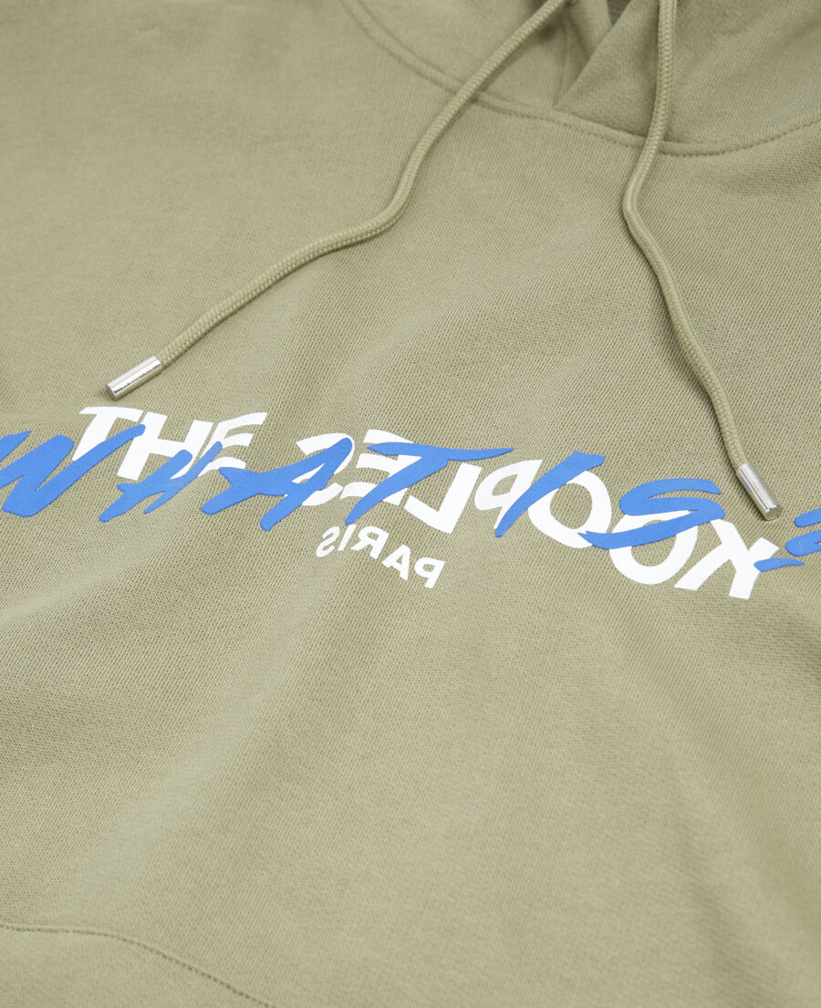 khaki hoodie with "what is" logo