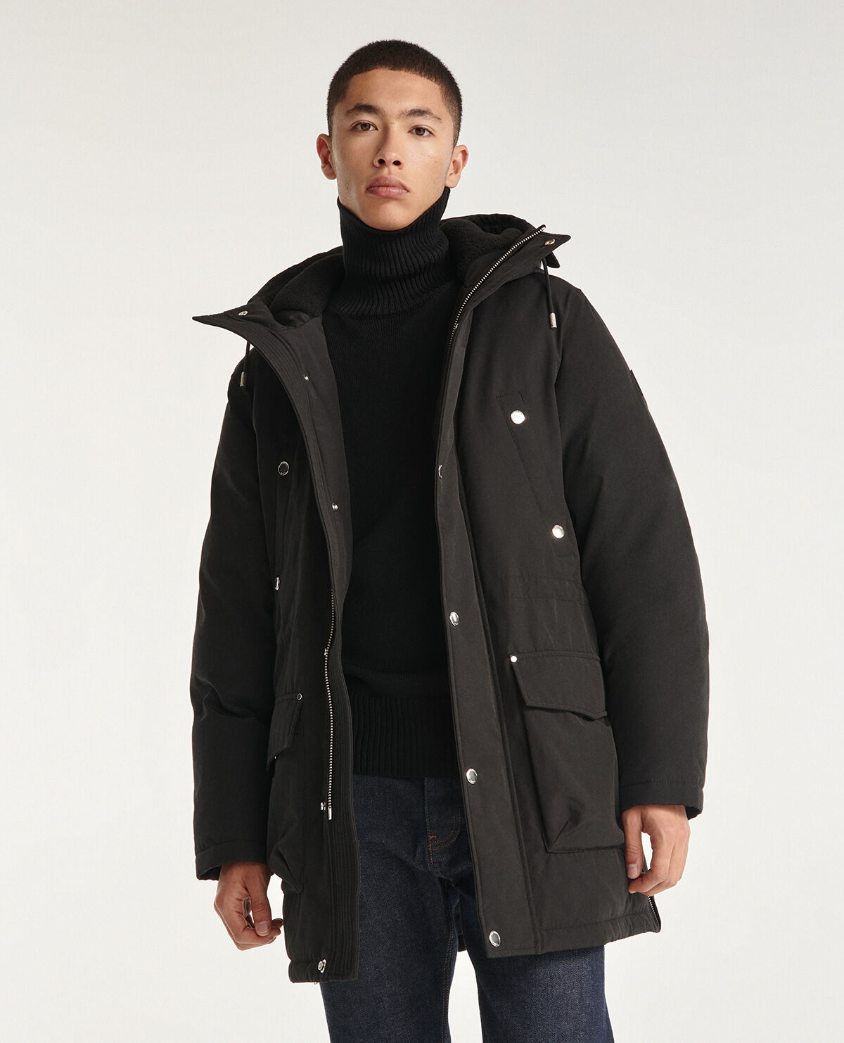 Hooded black parka and rubber logo pockets