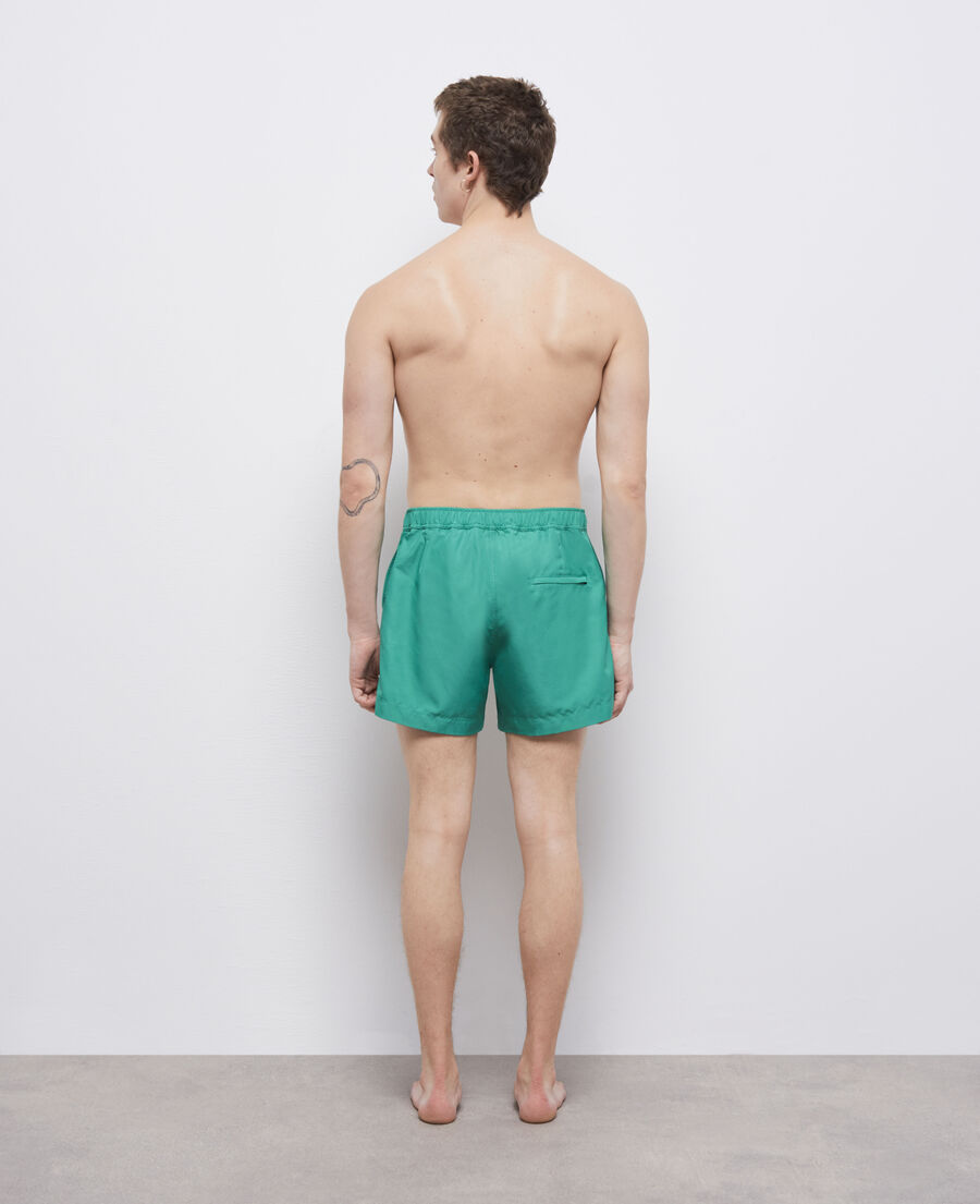 grüne badeshorts mit logo