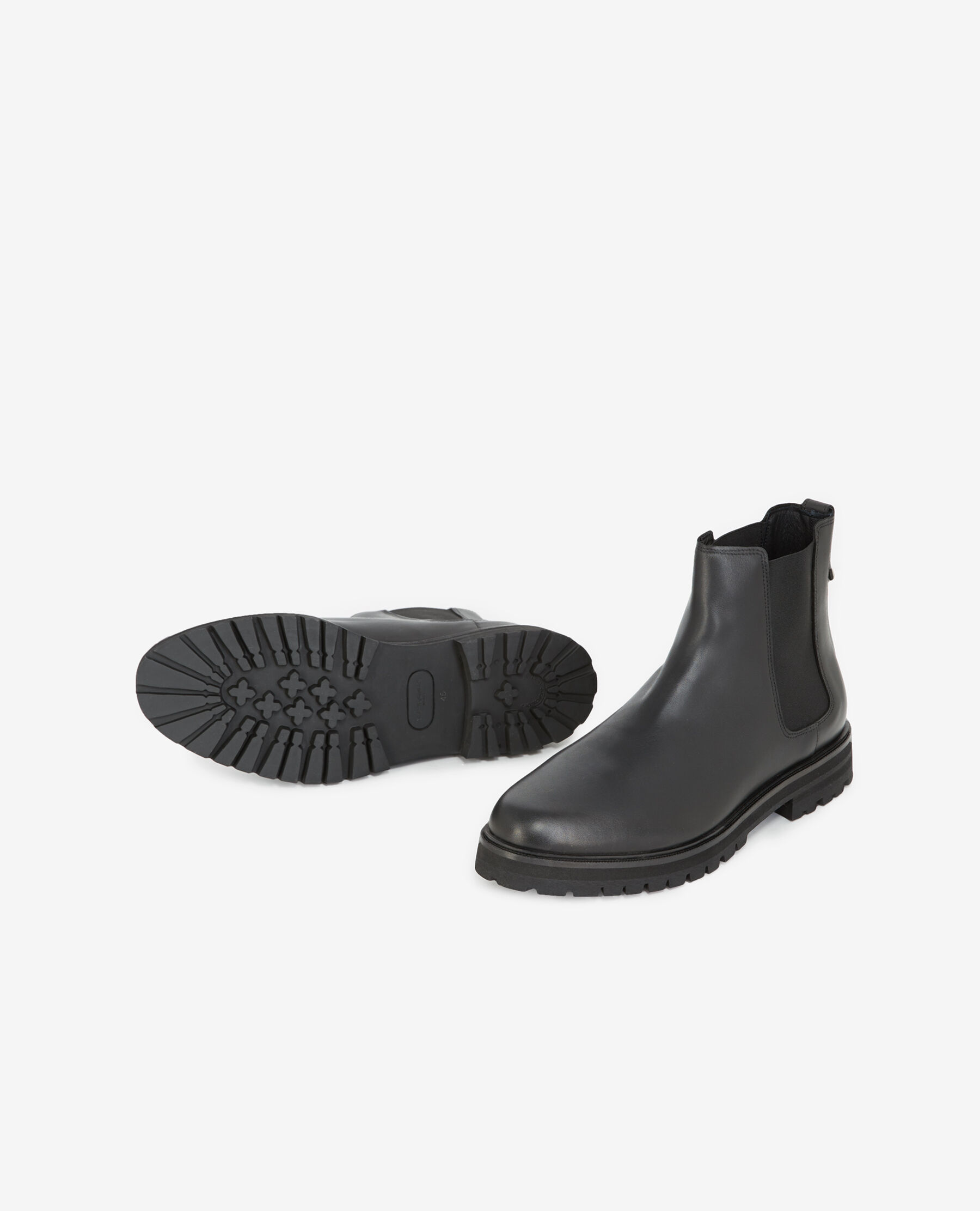 Black Chelsea boots with notched soles