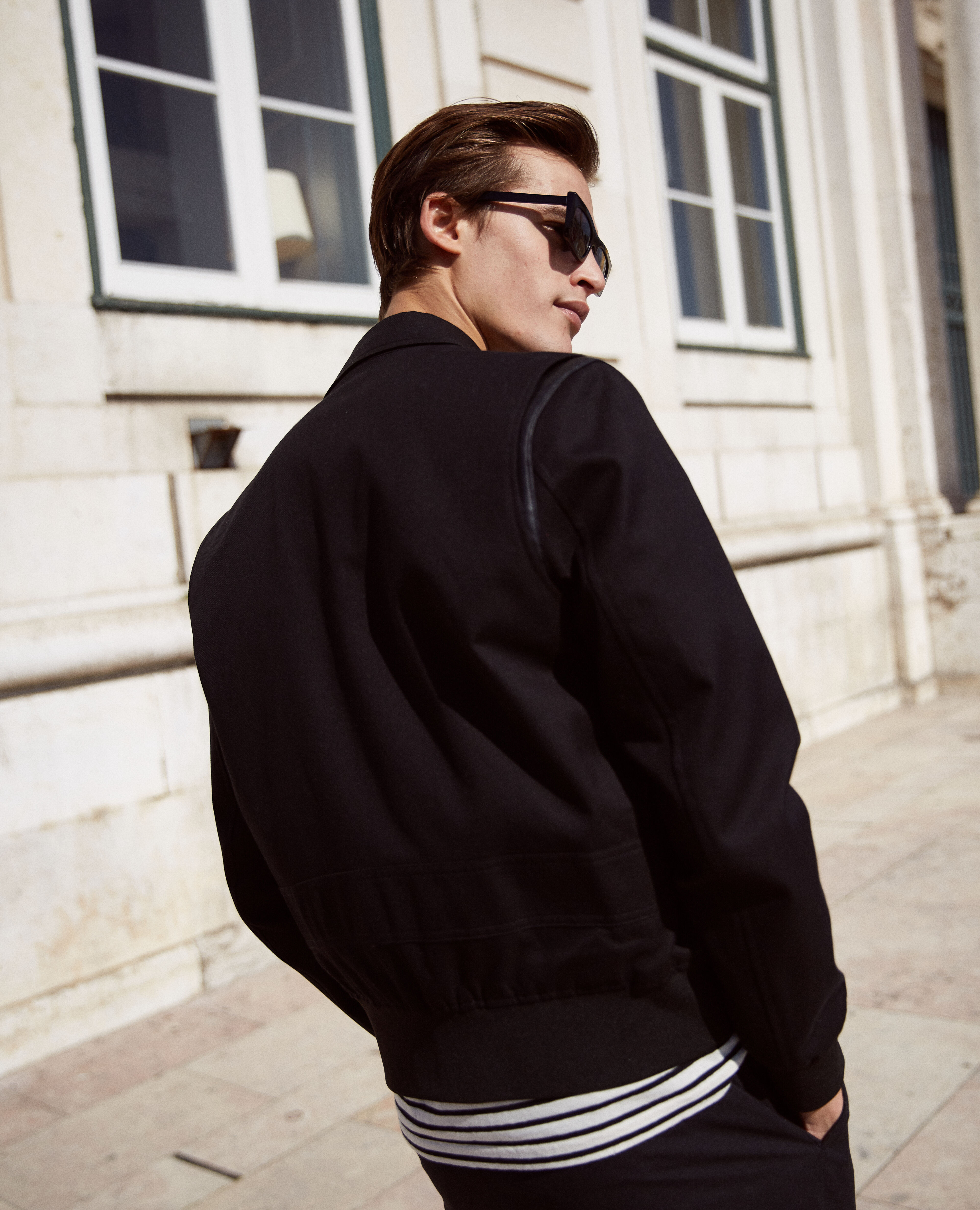 Black gusseted zip-up jacket with leather detail