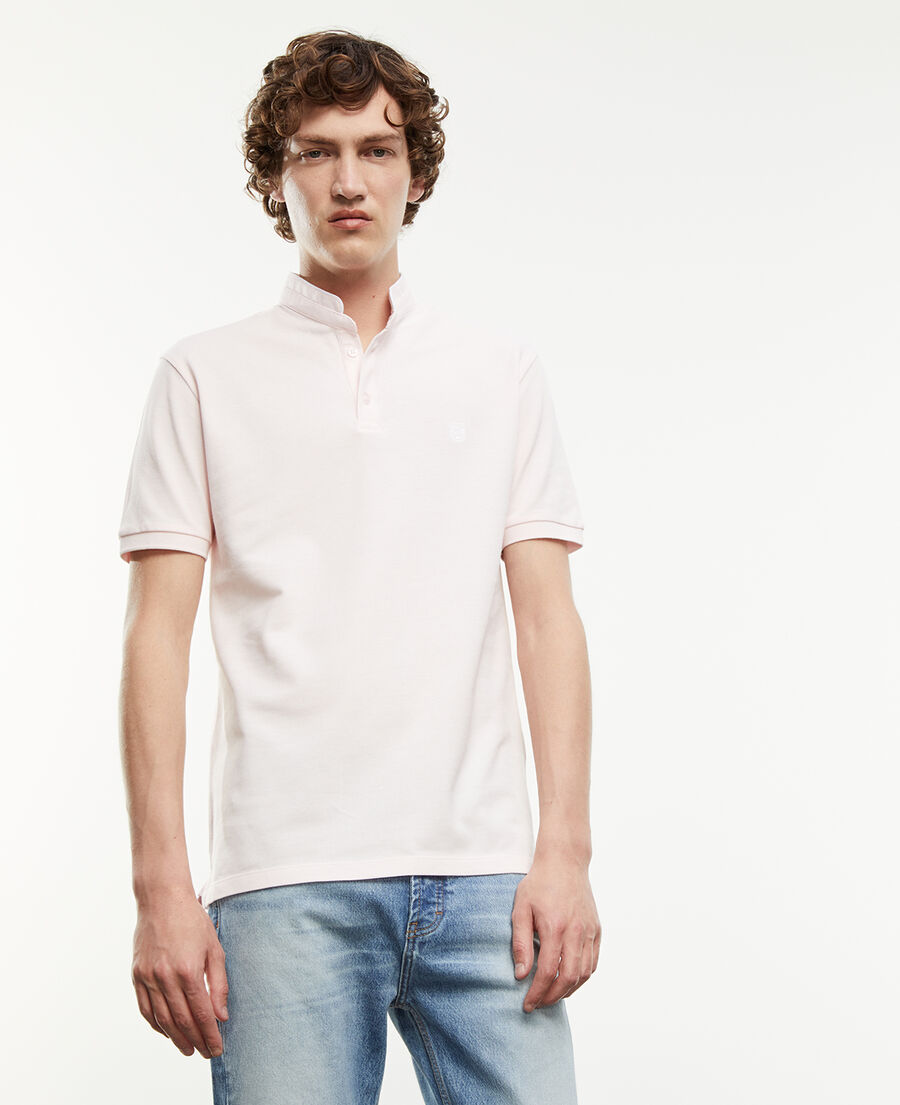 light pink polo shirt with white badge