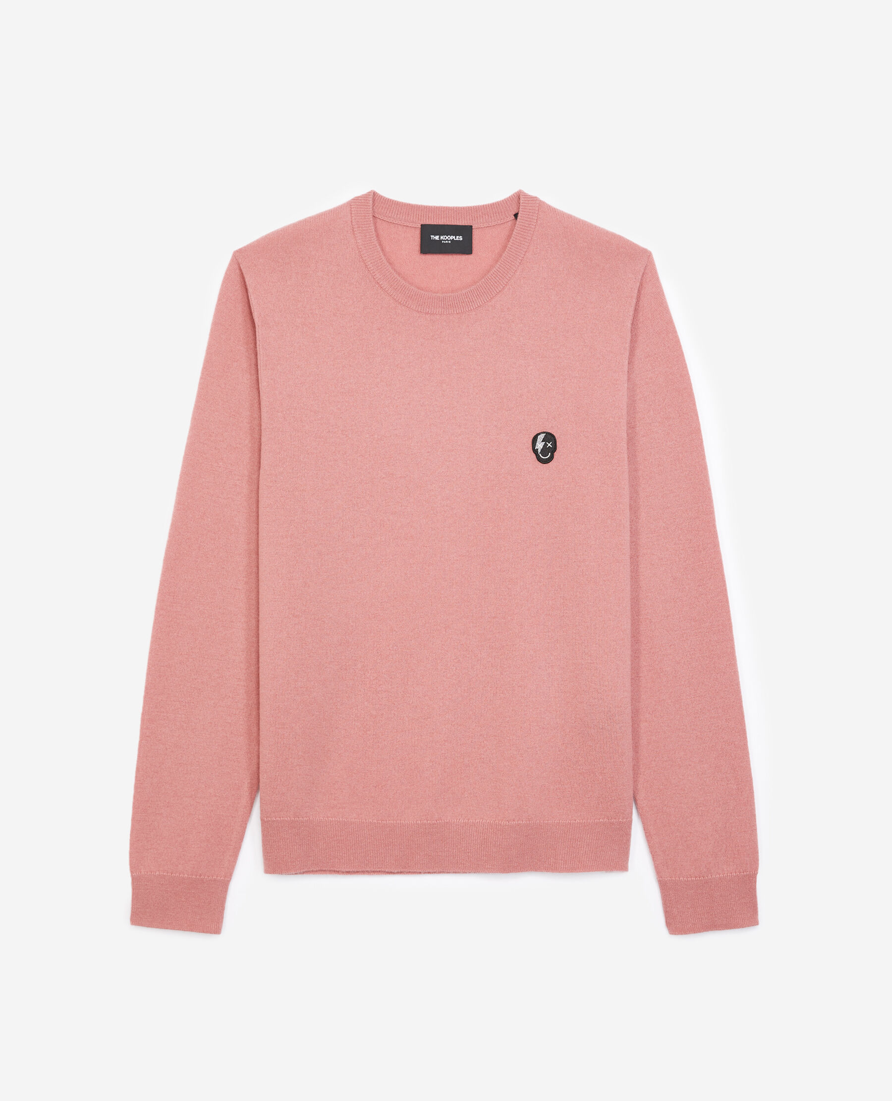 Knit pink sweater with skull badge