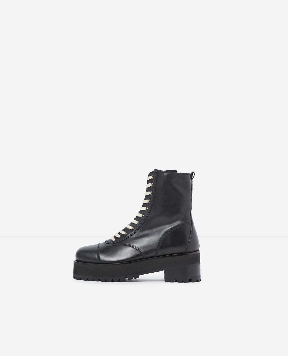 Black leather ankle boots with notched soles