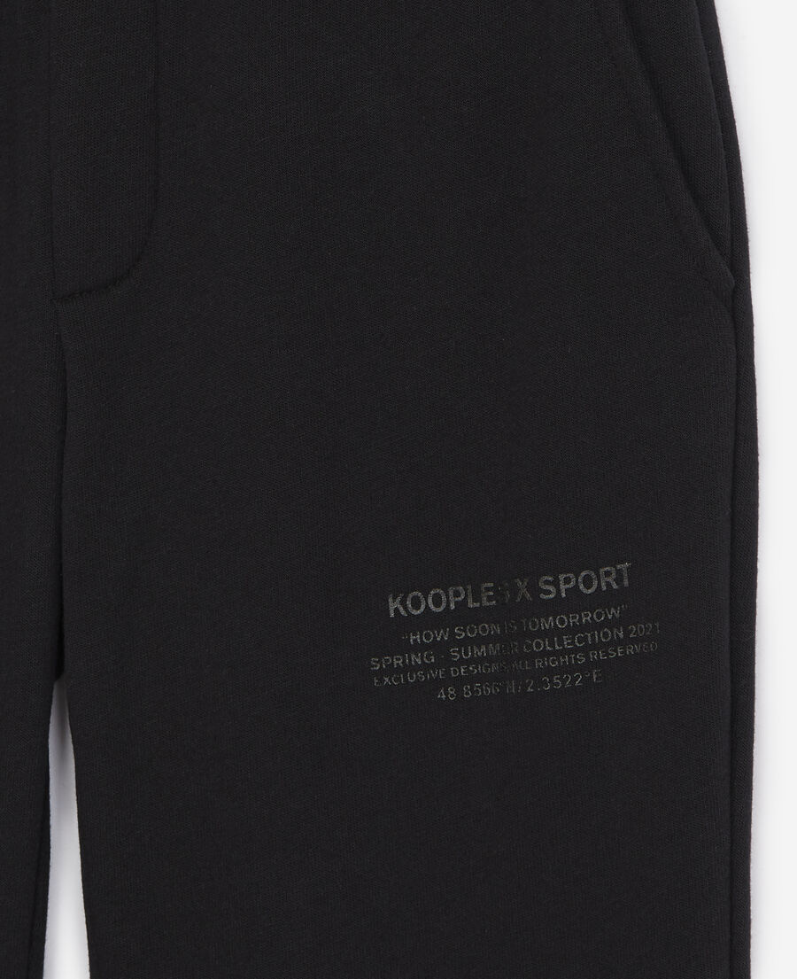 black joggers with rubber logo
