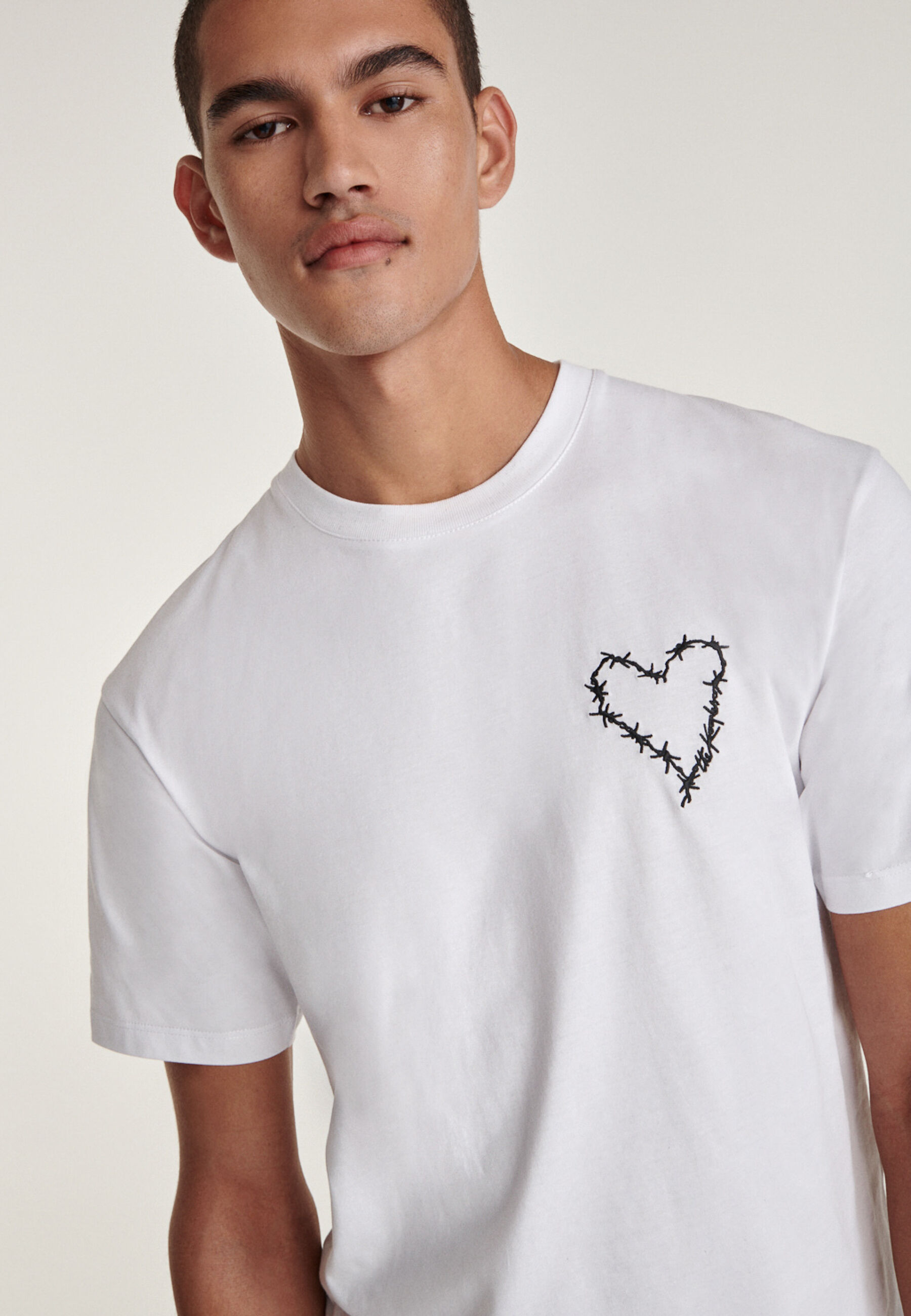 White T shirt with sewn in heart logo