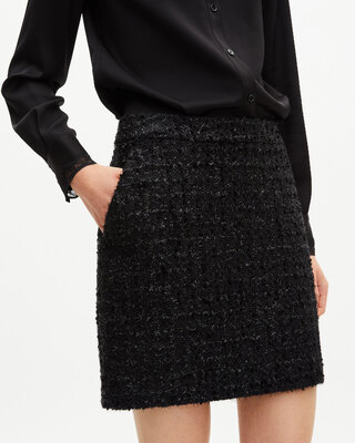 Falda corta de tweed negro brillante