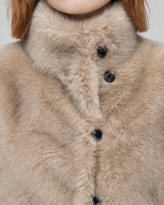 Manteau en fausse fourrure reversible beige et noir